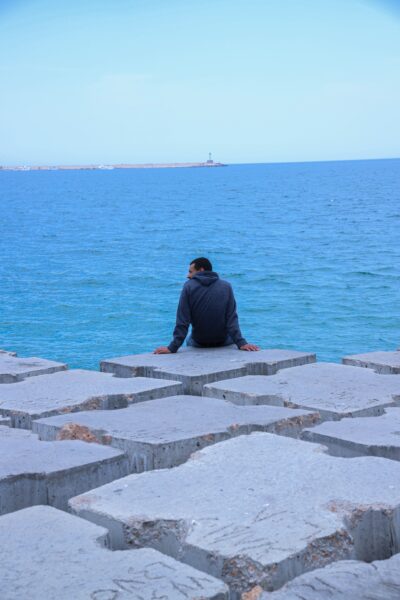 A man sitting in front of the sea