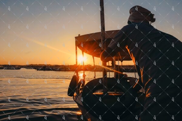 A man leads the boat in the middle of the Nile