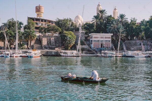 A boat returns to the Nile bank