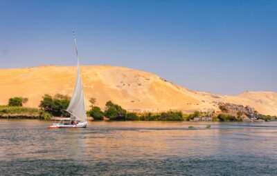 A sail boat in the middle of the Nile River
