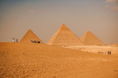 A family sitting in front of the pyramids