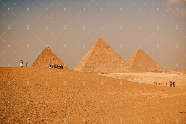 A family sitting in front of the pyramids