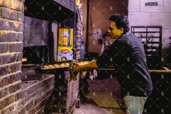 A man puts food inside the oven