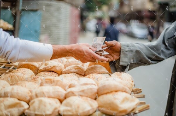 A man pays money for bread